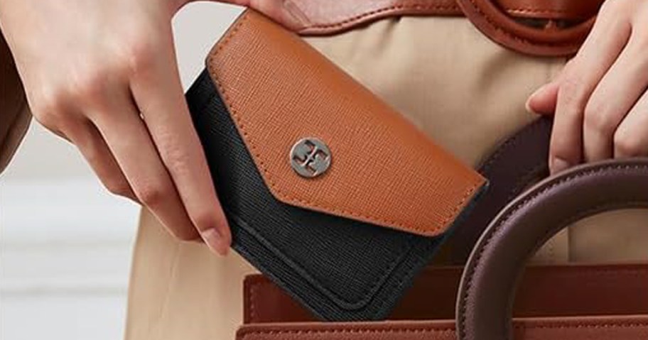 woman holding a small RFID Wallet