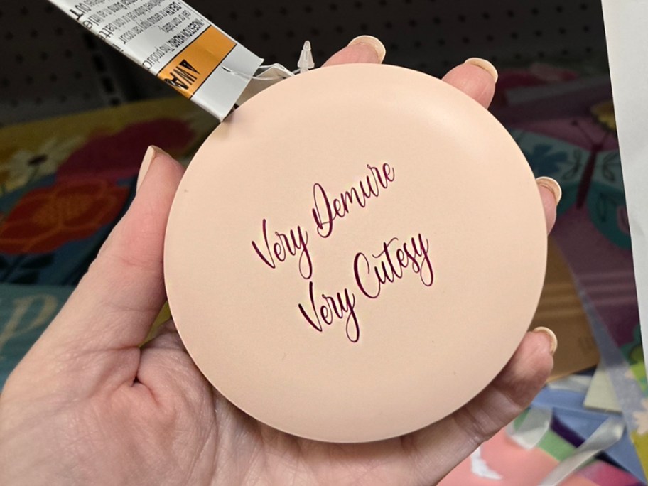 hand holding makeup mirror 