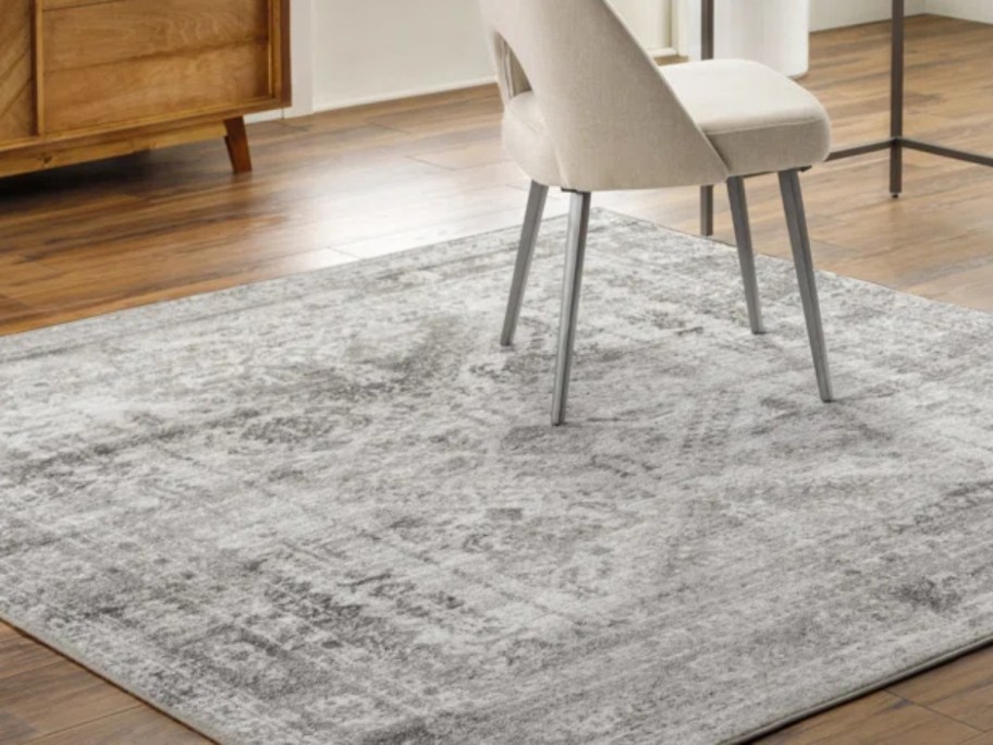 a grey and white oriental style rug in a home office