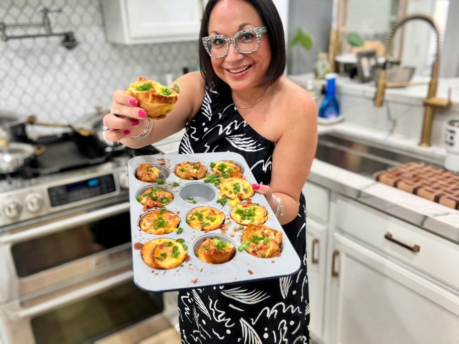 woman holding a ham and egg muffin cup 