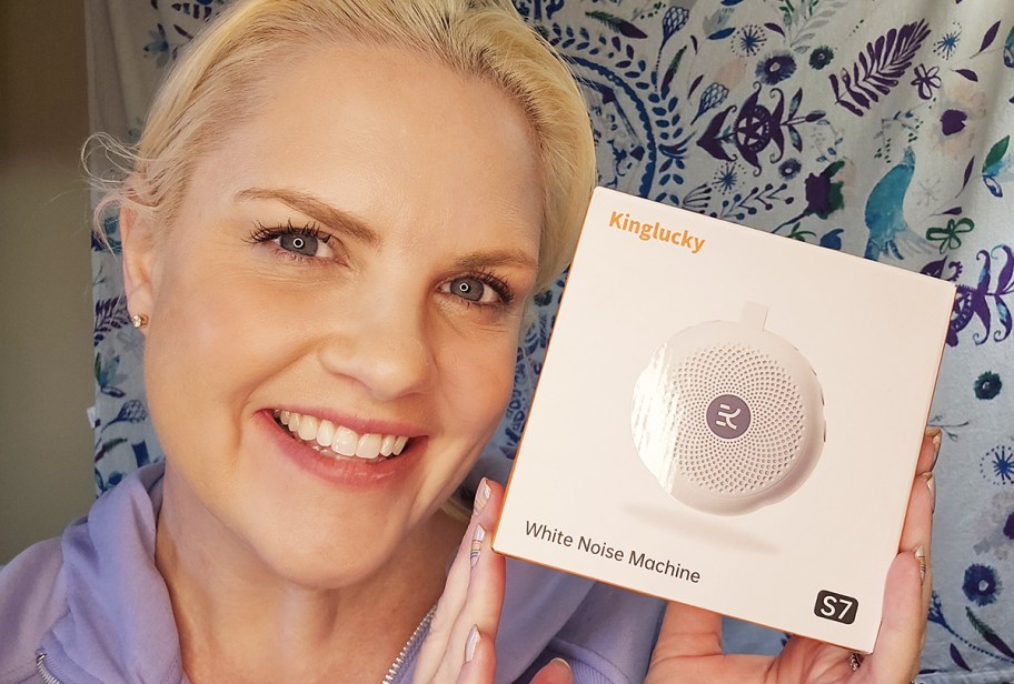 woman holding white noise machine