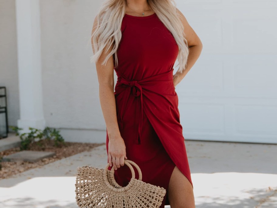 woman-wearing-red-wrap-dress-infront-of-her-home