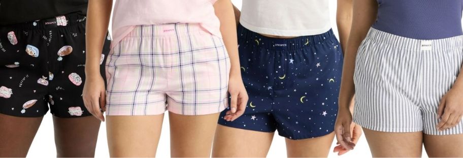4 models wearing womens boxer shorts in various designs