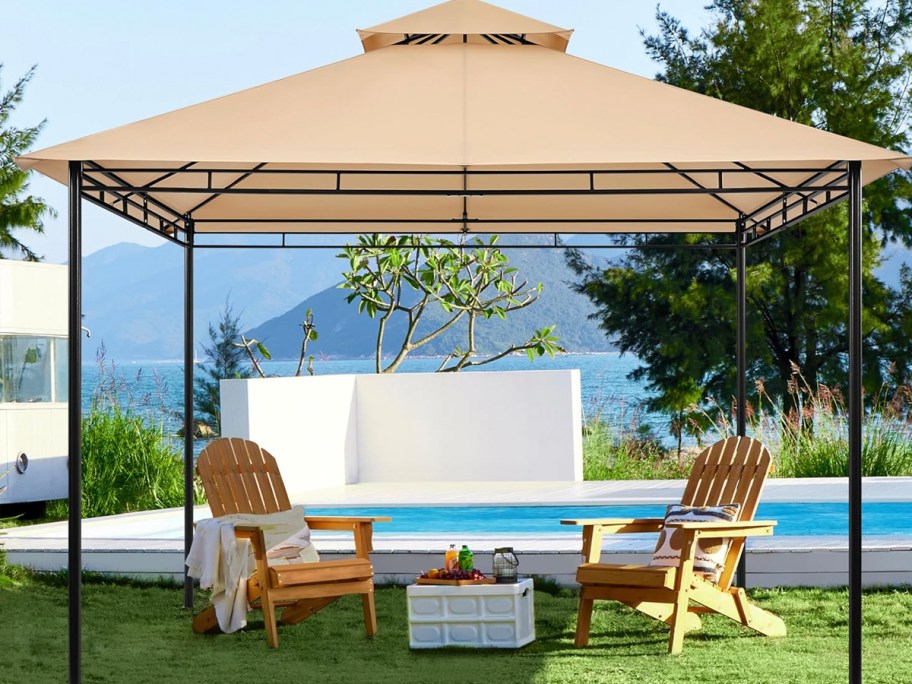 kahki gazebo near pool with chairs underneath