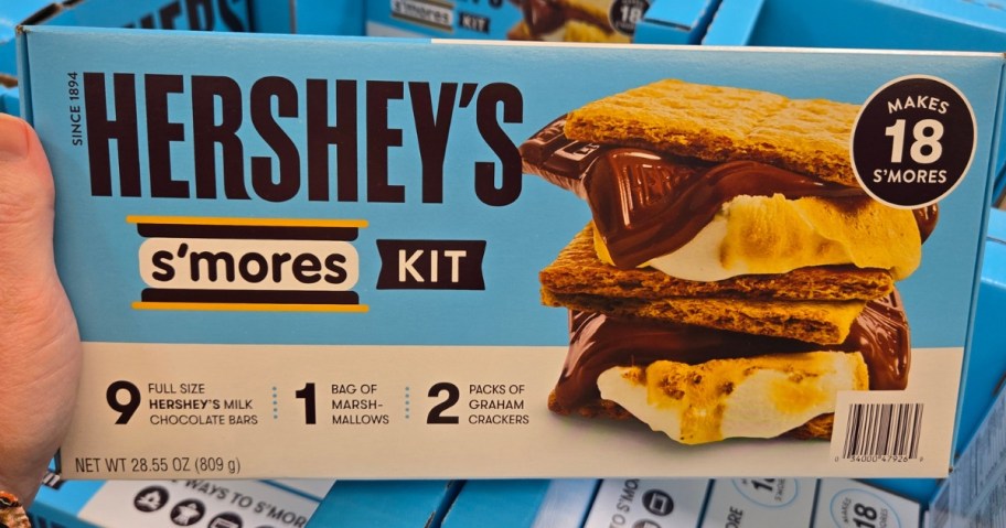 hand holding a HERSHEY'S S'mores Kit box in a store