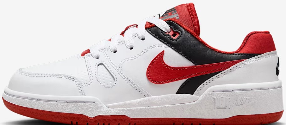 a kid's Nike show in white with red and black accents