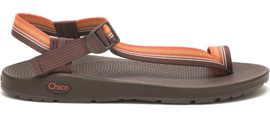 a brown sandal with orange stripe straps