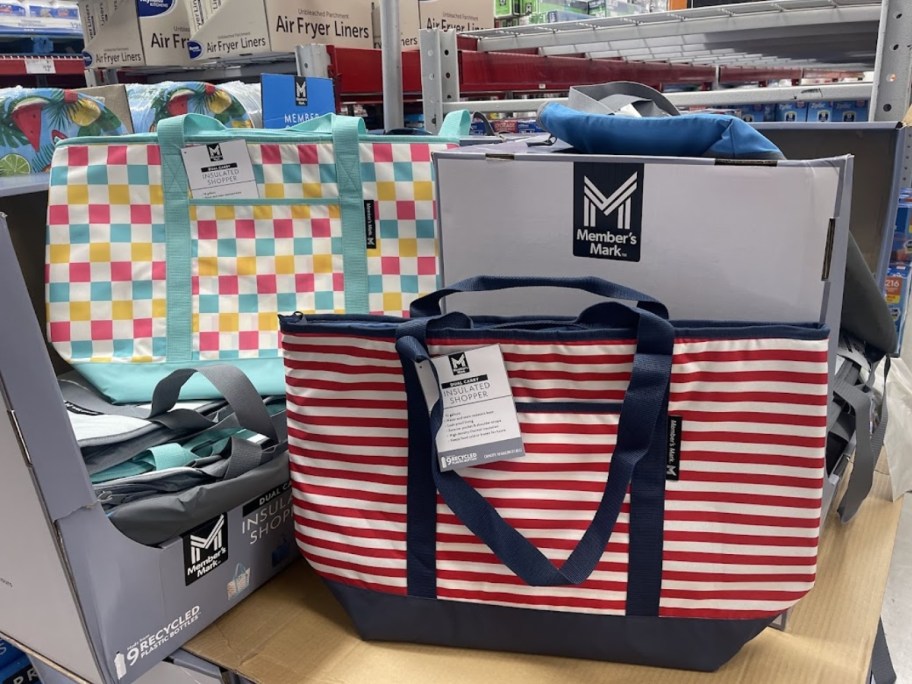 several stripe and patterned insulated shopping tote bags on display in Sam's Club