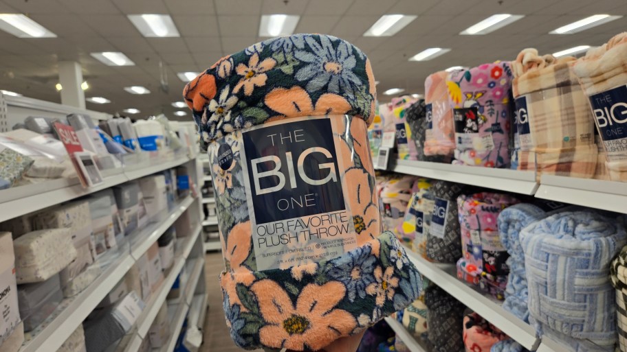 hand holding up a The Big One Throw in floral print