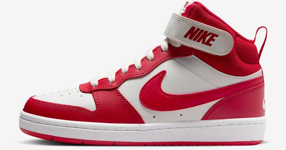 a kids' mid top Nike shoe in red and white