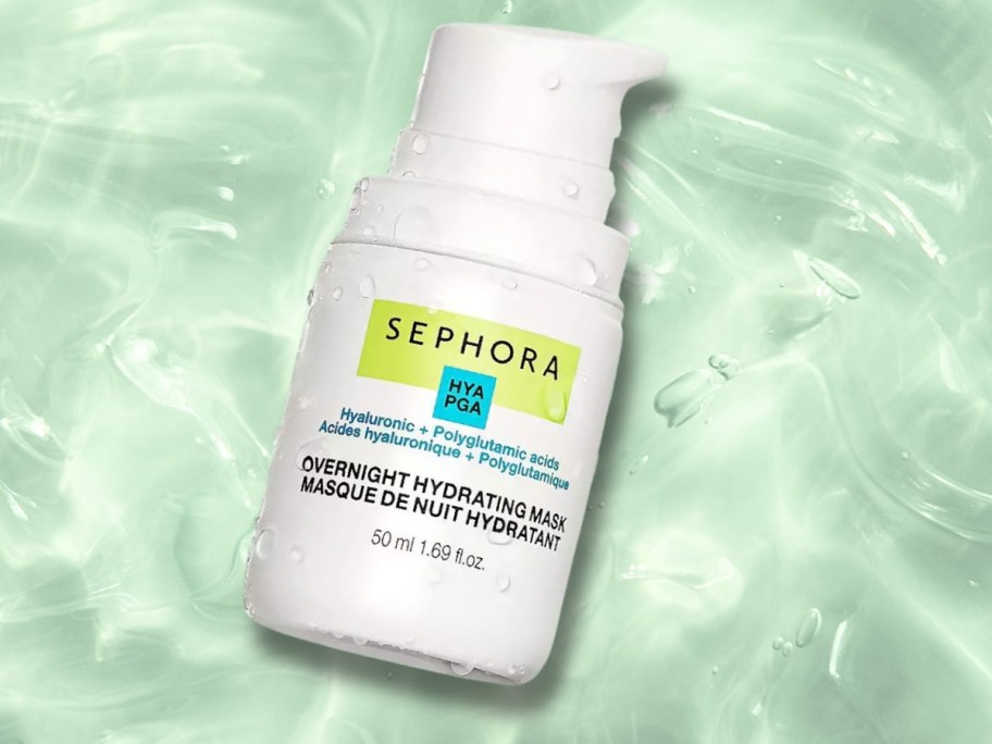a bottle of facial serum with water around it
