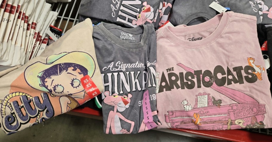 3 women's vintage washed graphic character t-shirts on a display table