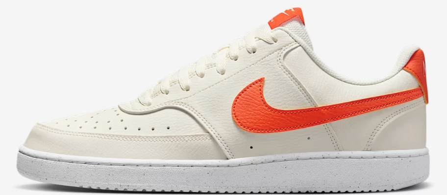 a men's Nike shoe in off white with orange accents