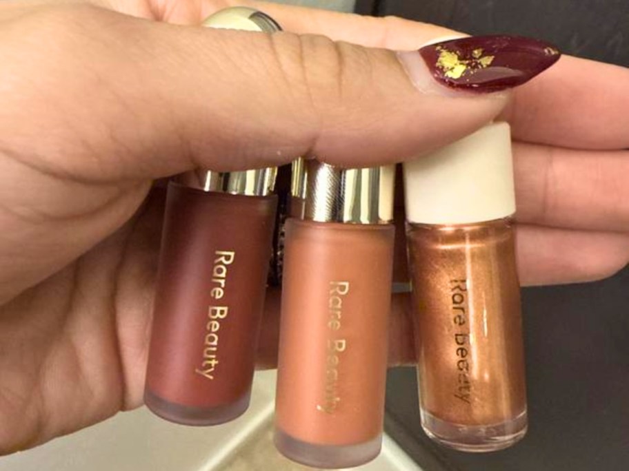 hand holding 3 blush roll ons