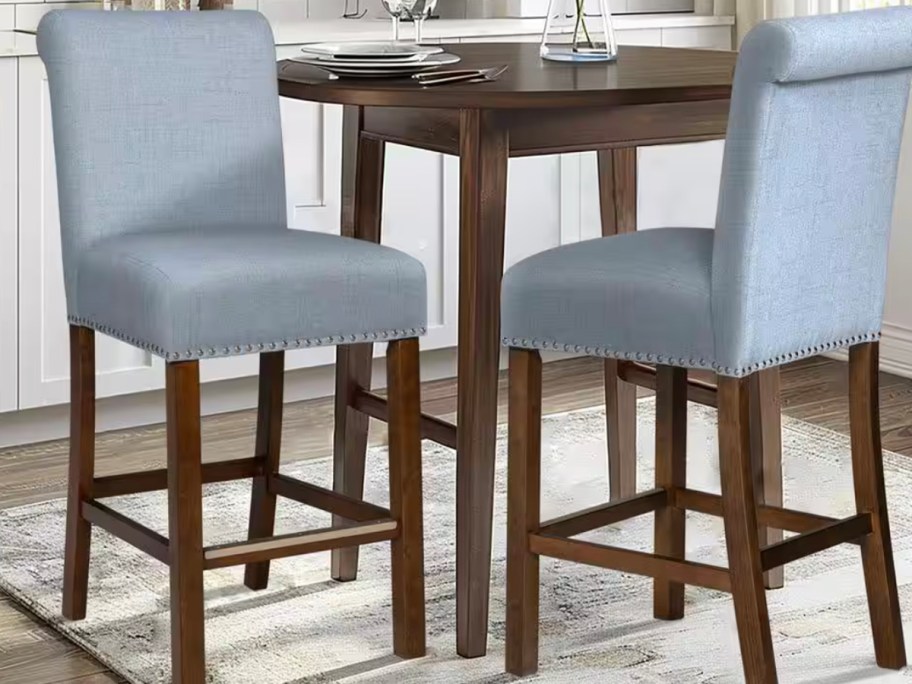 two blue and brown counter stools 