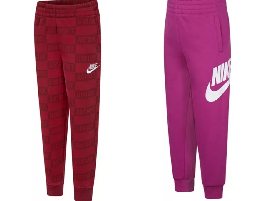 2 pairs of Nike kids joggers, one is red, the other is hot pink