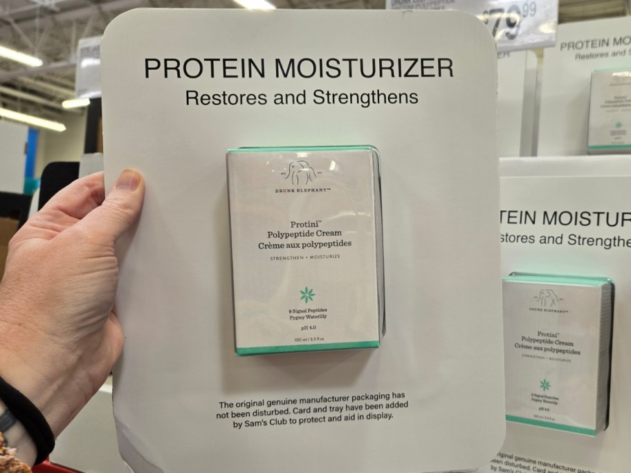 hand holding a package of Drunk Elephant protein moisturizer
