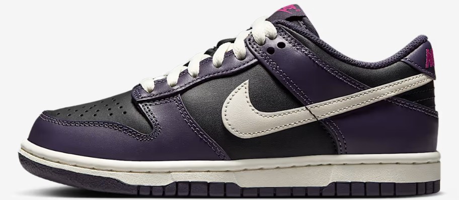 a kids Nike Dunk shoe in purple and white