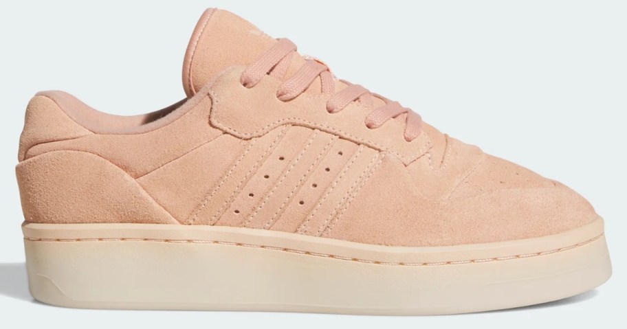 a peach and off white women's adidas shoe