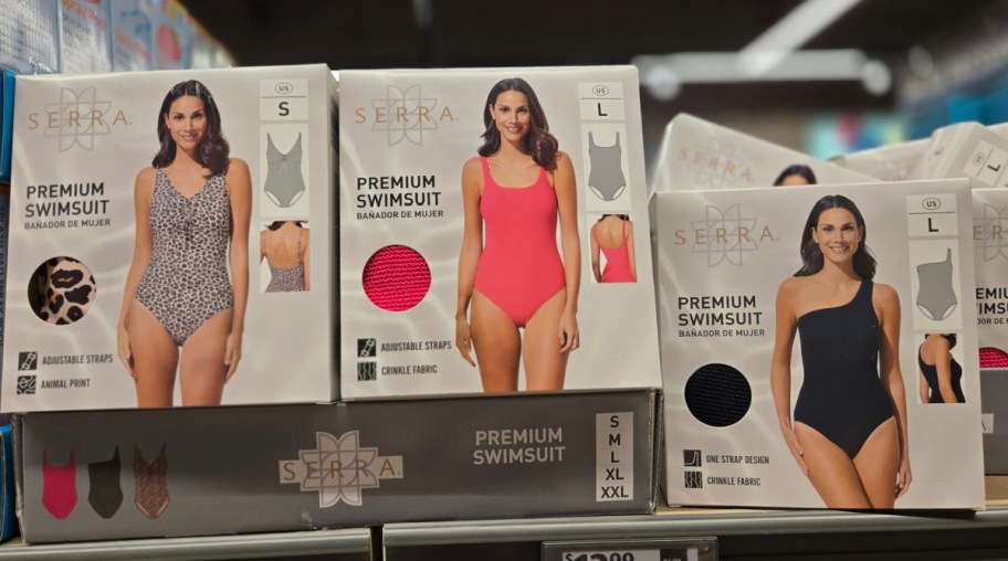 Three different ALDI swimsuits in fun colors and a cheetah print pattern all on a shelf