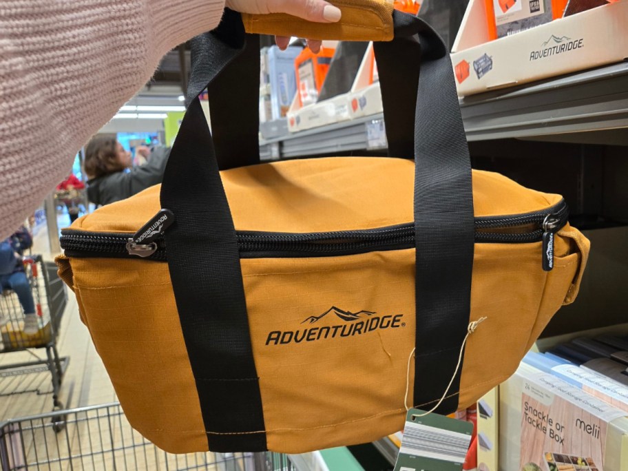 hand holding yellow canvas camping bag at the ALDIs store