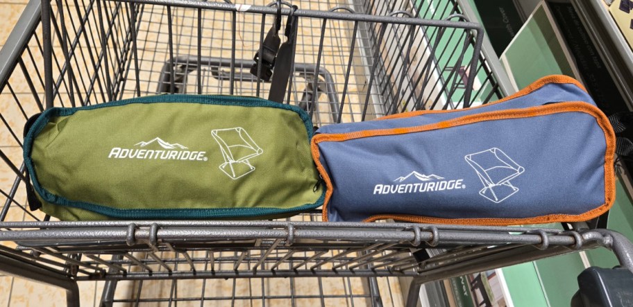 two different color camping chairs inside of their bags inside of an ALDIs shopping cart