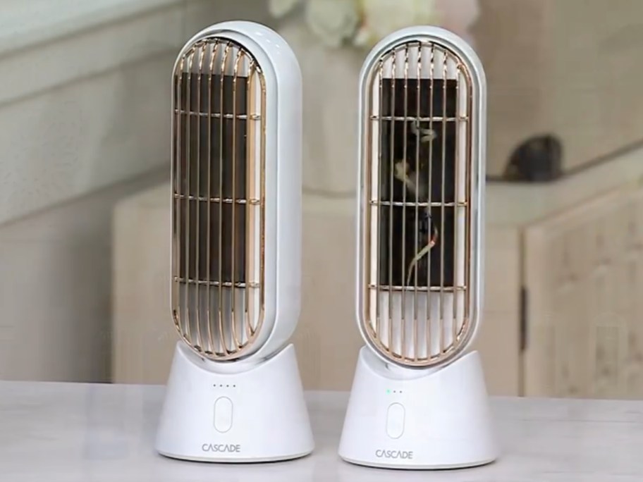 two white cascade fans displayed on top of the table 
