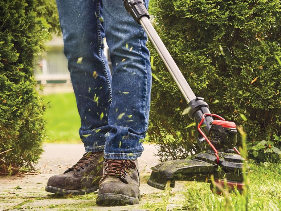 man using a craftsman string trimmer