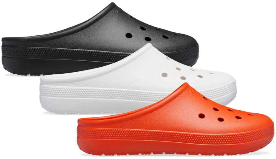 Crocs Adult Classic Low Profile Clogs in black, white, and orange, featuring a backless slip-on design with ventilation holes and textured soles.