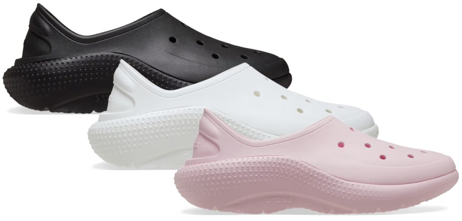 Crocs Adult Classic Sneakers in black, white, and pink, featuring a sleek closed-back design, perforated uppers, and cushioned textured soles.