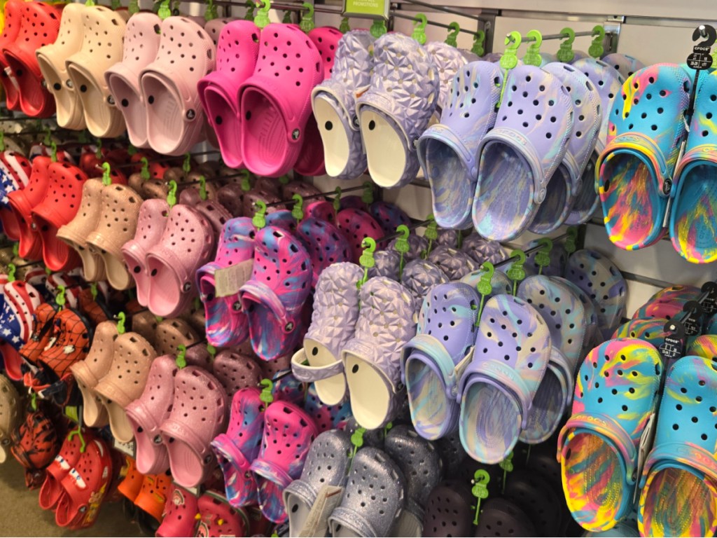 Colorful pairs of crocs on display inside store