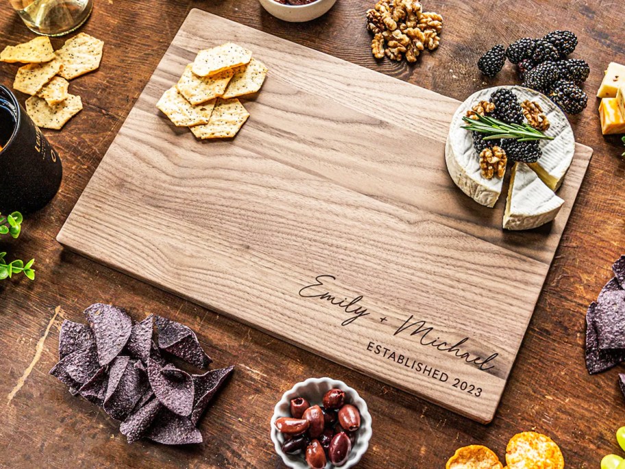 engraved cutting board with crackers and cheese on top