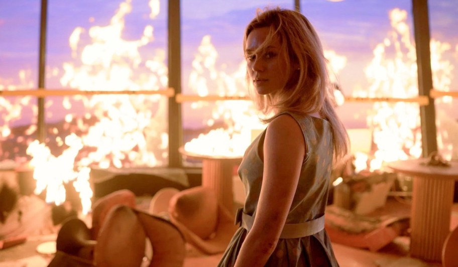 woman standing in a room on fire