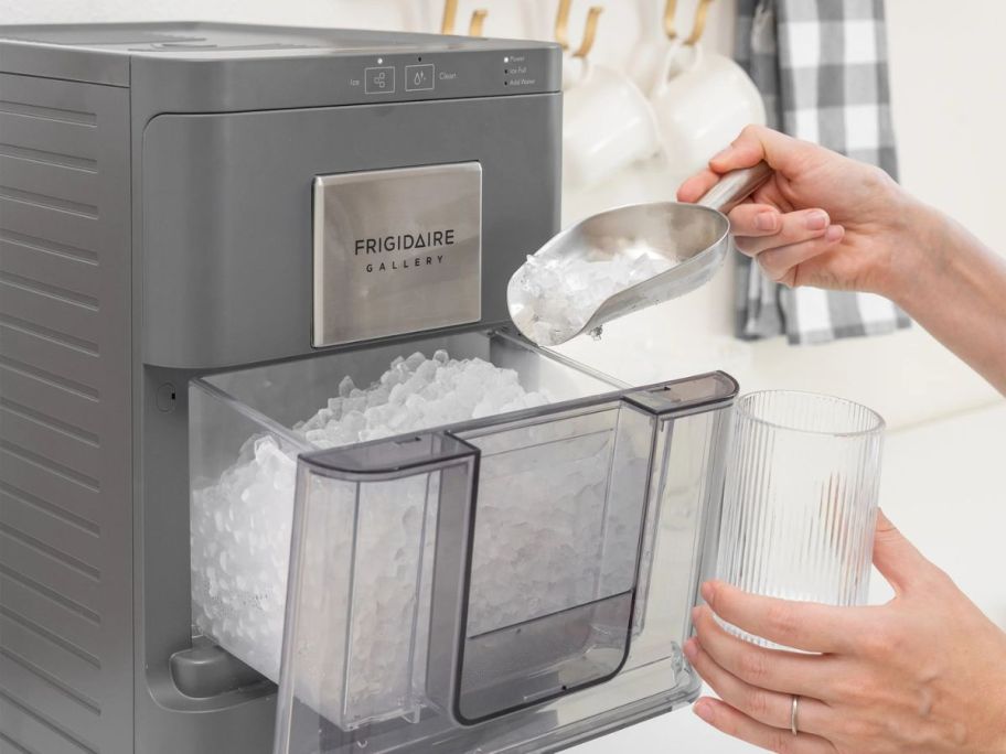 A person getting ice from a Frigidaire Nugget Ice Maker