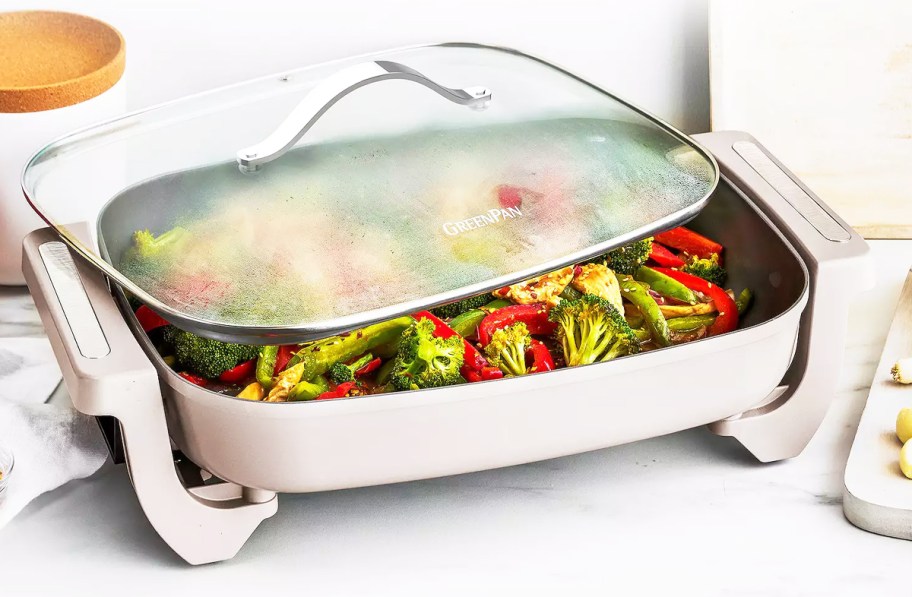 stir-fry veggies inside an electric skillet with glass lid