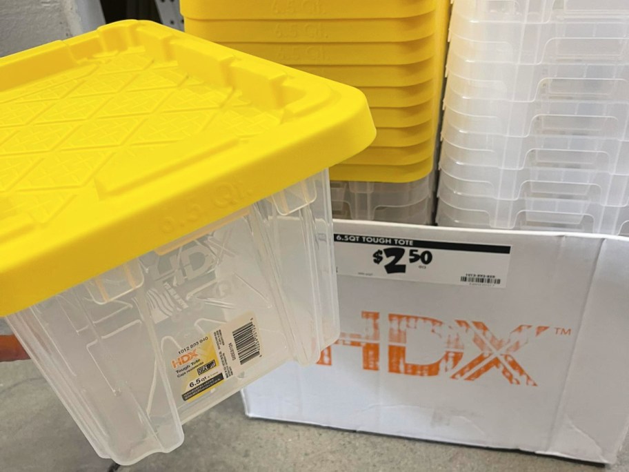 HDX clear storage tote with yellow lid and a sale sign