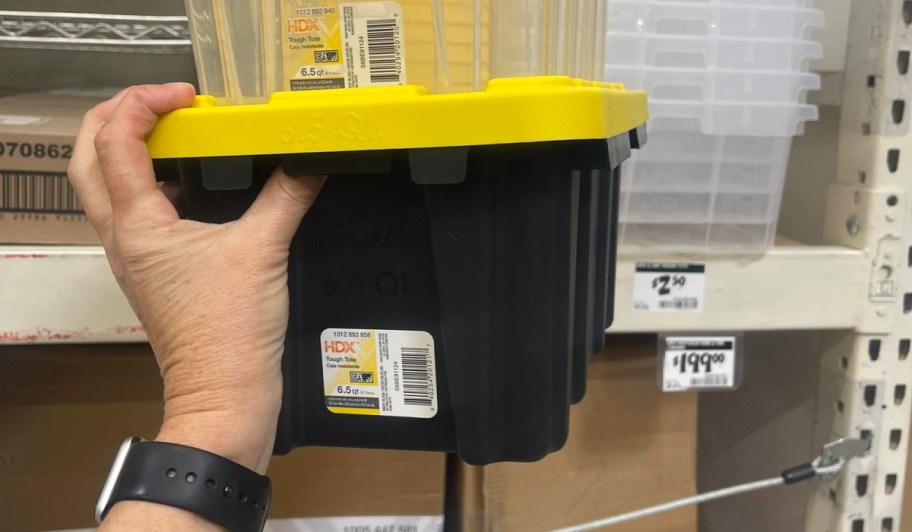 black and yellow HDX storage tote in hand