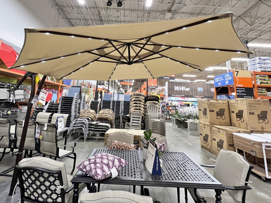 tan cantilever umbrella with led lights on display in home depot