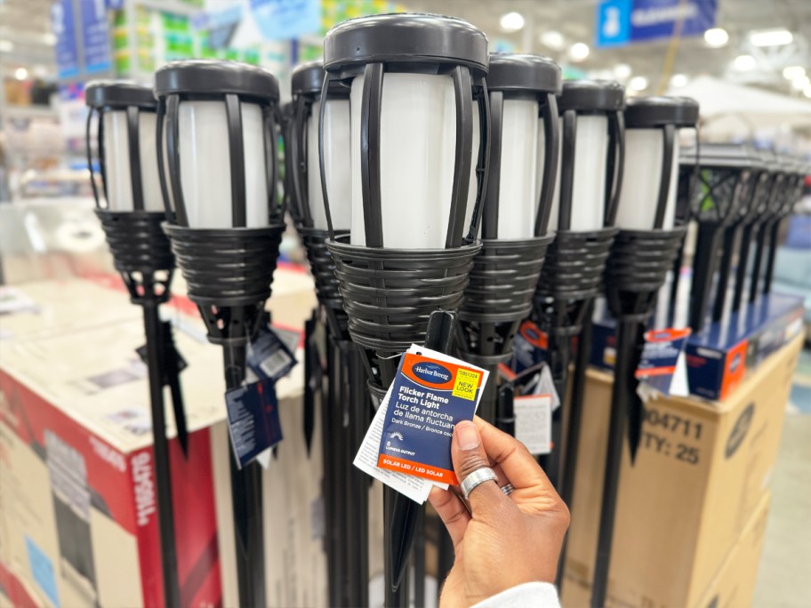 hand holding tag to Harbor Breeze Flicker Flame Tiki Torch