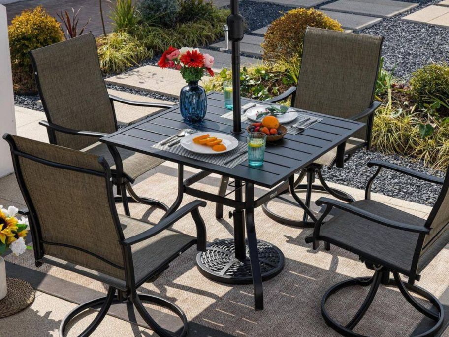 An outdoor dining table with an umbrella 