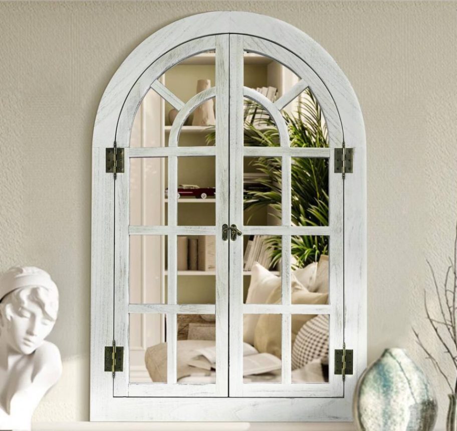A Hochwertiges Farmhouse Arched Windowpane Mirror on a wall