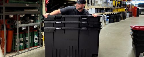 A man inside a huge plastic storage box