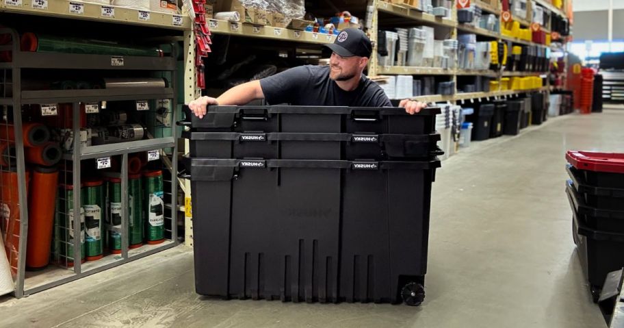 A man inside a huge plastic storage box