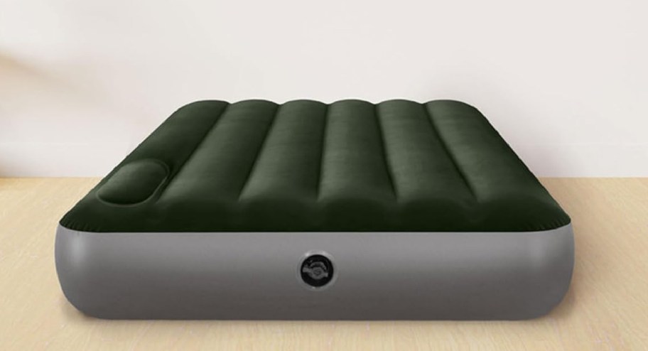 green intex twin air mattress displayed on a wooden floor