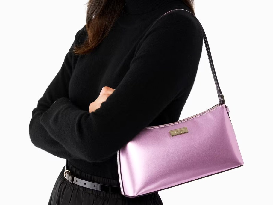 woman in a black top with a metallic purple shoulder bag