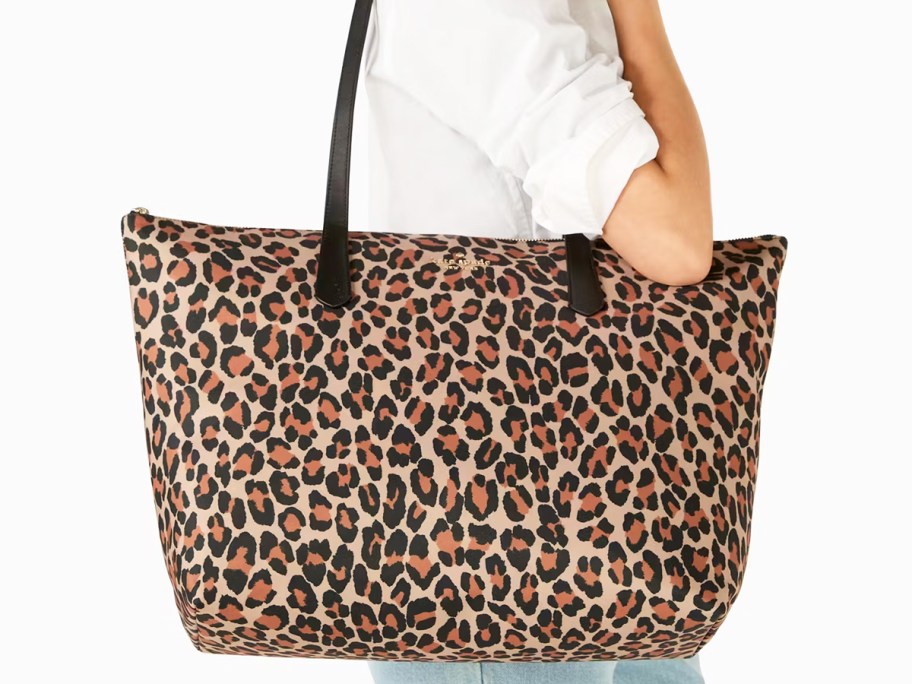 woman carrying a large leopard print tote bag