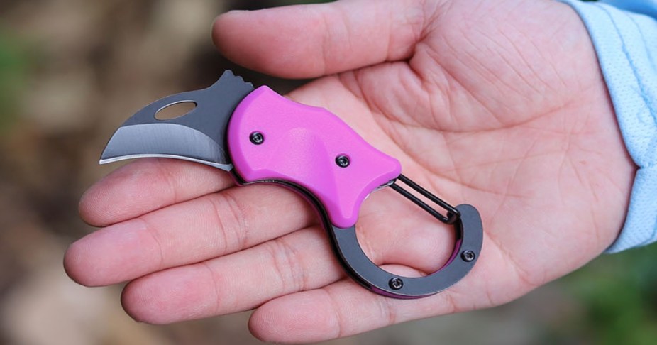 Hand holding a Pink Keychain Knife cutter 