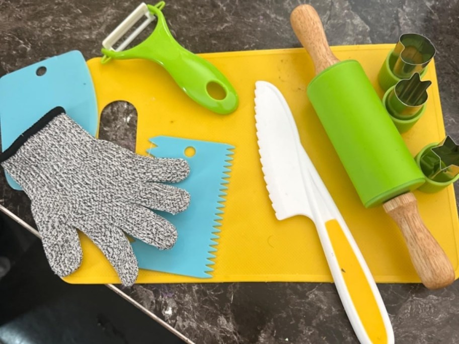 kids cooking utensil set laid out on kitchen countertop