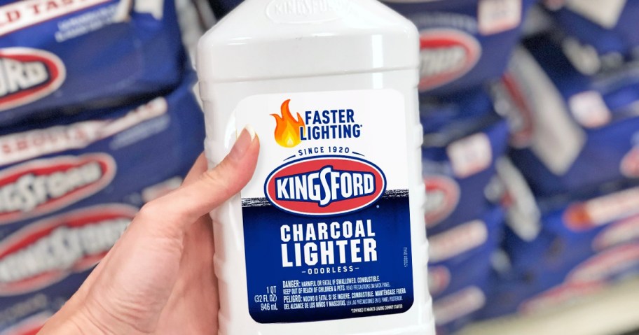 hand holding a bottle of Kingsford Lighter Fluid