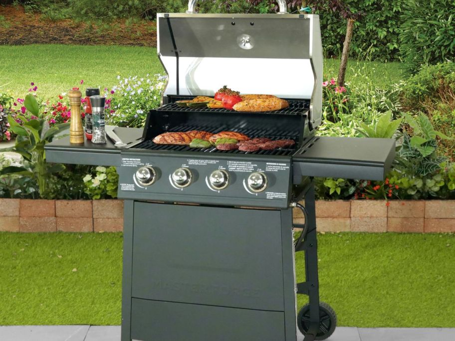 An open Master Forge Stainless Steel 4-Burner Liquid Propane Gas Grill